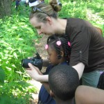 Michelle Navarre, Head of School, teaches a Kindergartner about photography